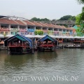 Boote auf dem Singapore River vor bunten Häusern